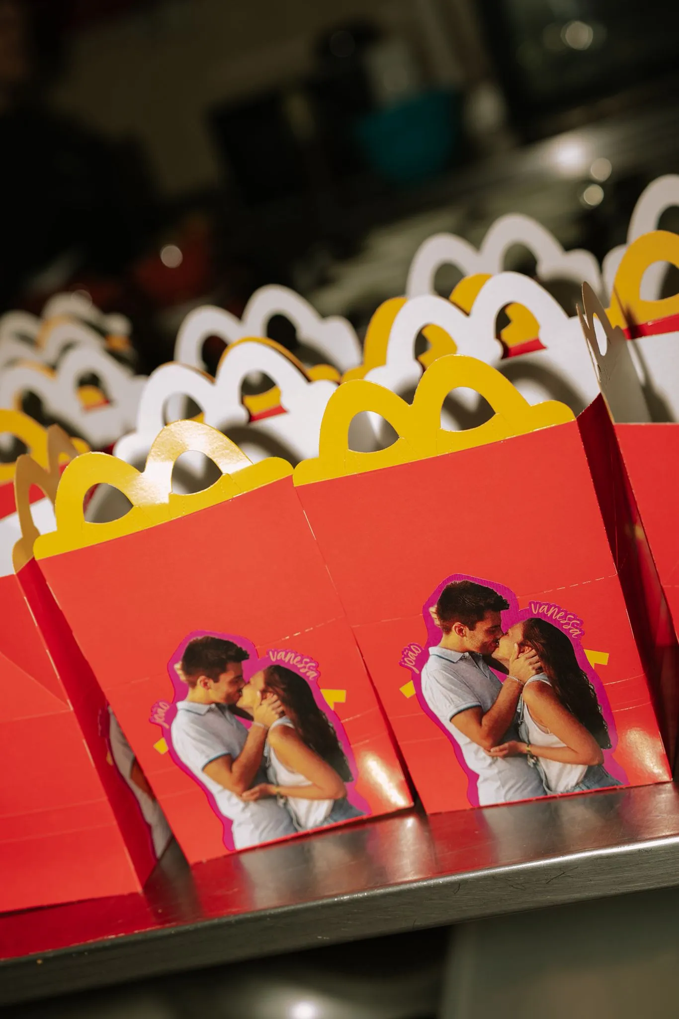 Red and gold favour boxes printed with a couple's photograph
