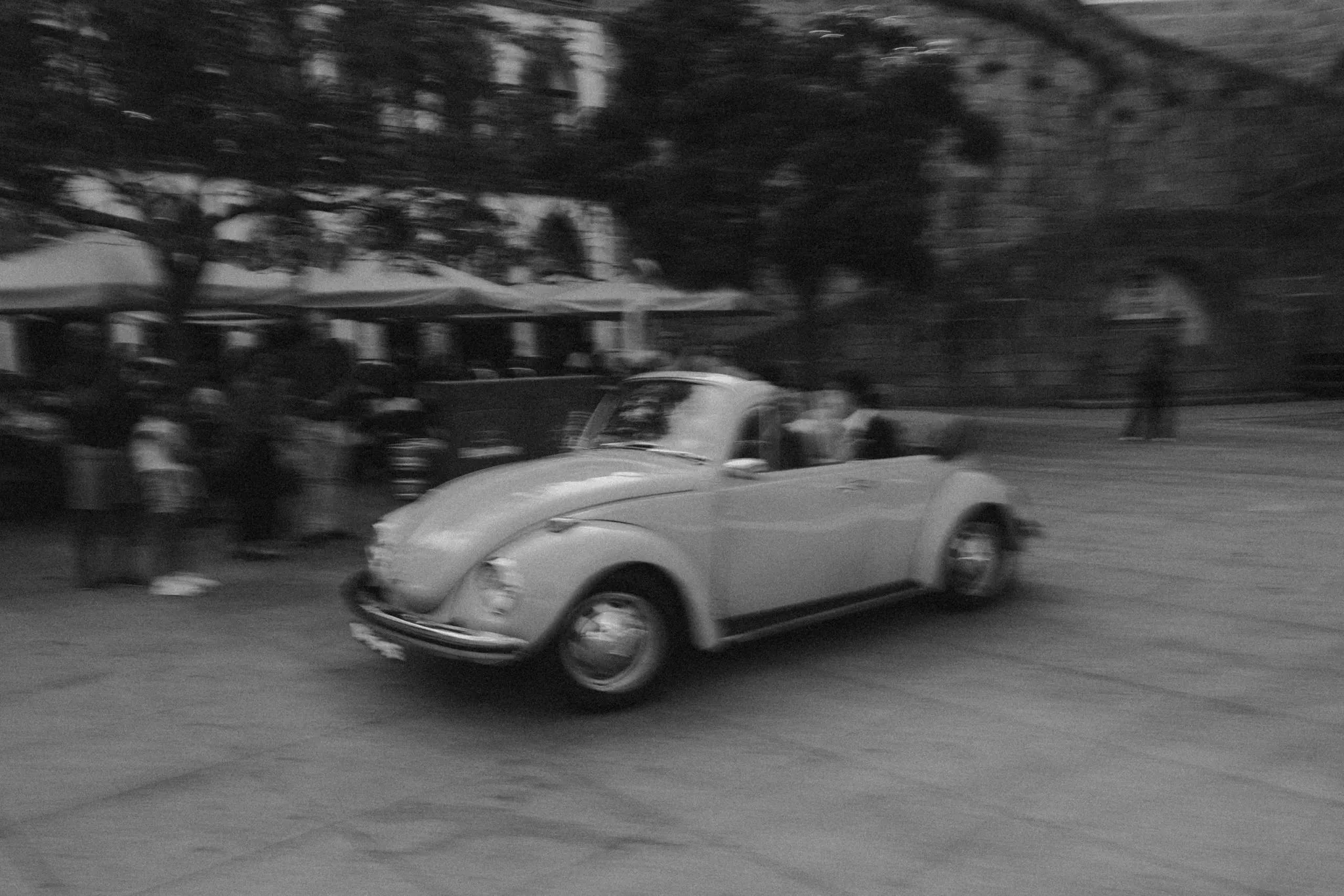 A vintage Beetle in motion, captured in soft black and white